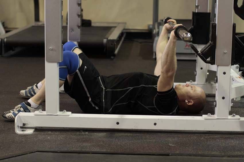 Barbell Floor Press demonstration, start of the movement, targeting the chest