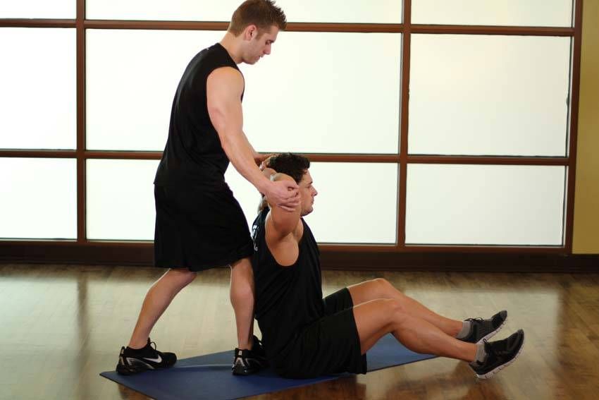 Behind-the-Head Chest Stretch demonstration, start of the movement, targeting the chest