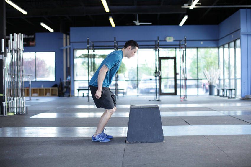 Box Jump demonstration, start of the movement, targeting the quads