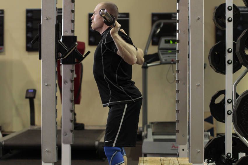 Box Squat demonstration, start of the movement, targeting the quads