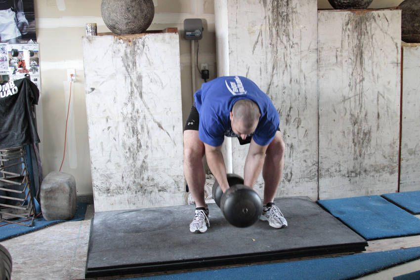 Circus Dumbbell Press demonstration, start of the movement, targeting the shoulders