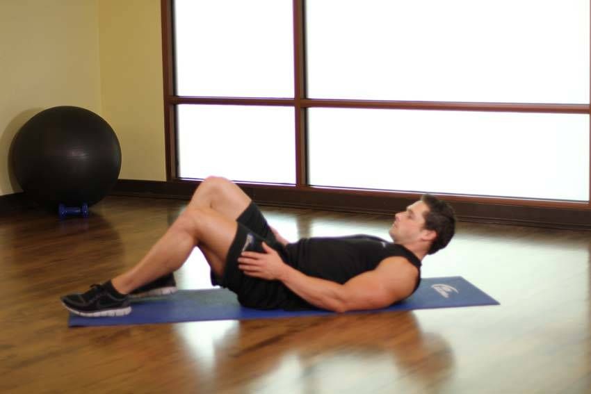 Figure-Four Glute Stretch demonstration, start of the movement, targeting the glutes