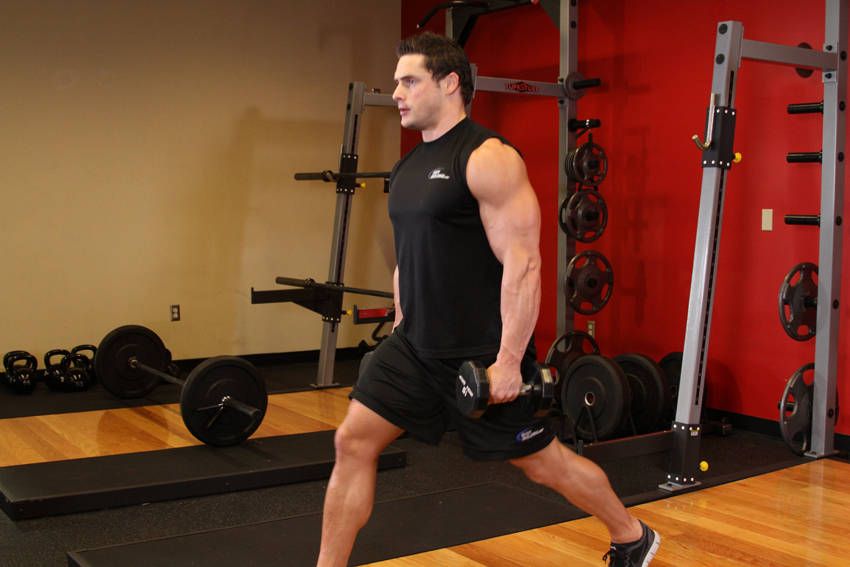 Dumbbell Forward Lunge demonstration, start of the movement, targeting the quads