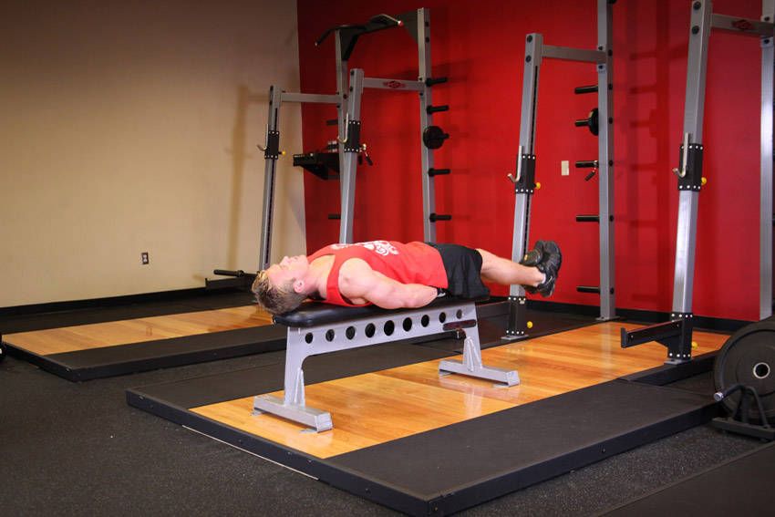 Lying Leg Raise demonstration, start of the movement, targeting the abs