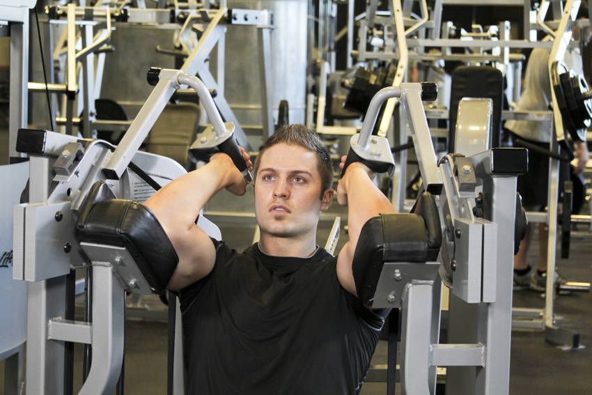 Machine Tricep Extension demonstration, start of the movement, targeting the triceps