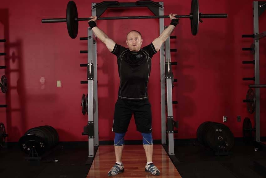Overhead Squat demonstration, start of the movement, targeting the quads
