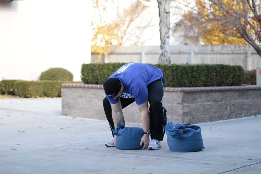 Sandbag Load demonstration, start of the movement, targeting the quads