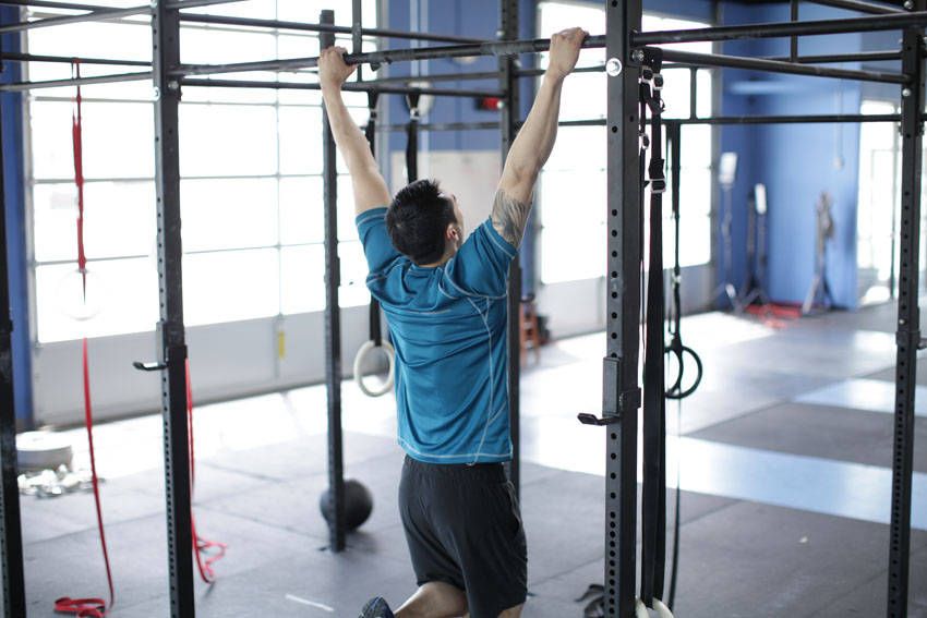 Scapular Pull-Up demonstration, start of the movement, targeting the traps