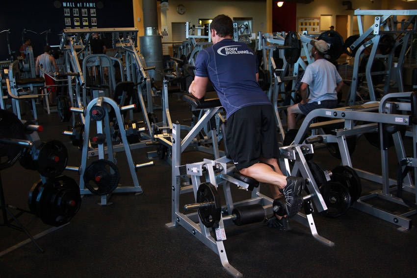 Standing Leg Curl demonstration, start of the movement, targeting the hamstrings