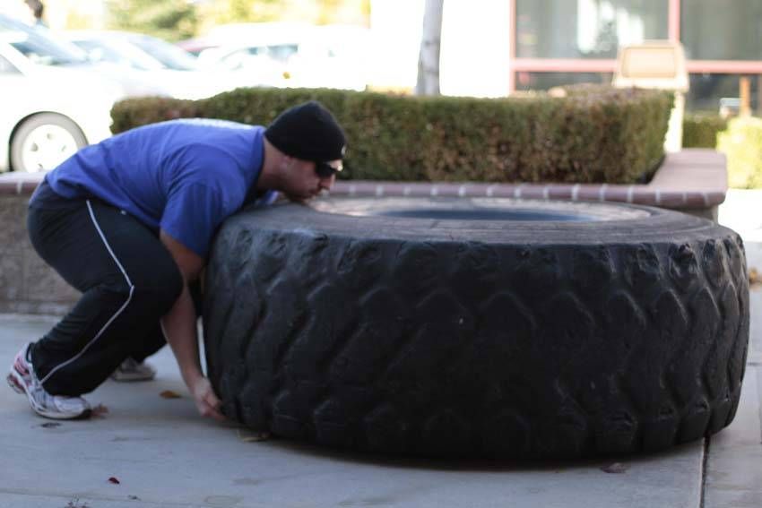 Tire Flip demonstration, start of the movement, targeting the quads